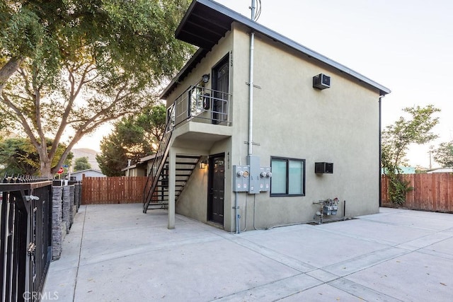 view of property exterior featuring a patio area and a balcony