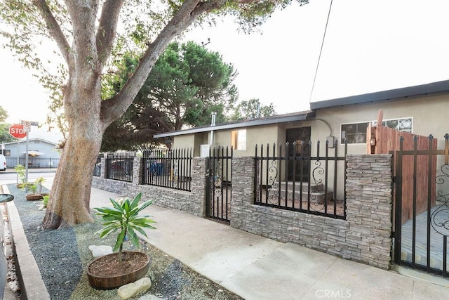 view of gate with a fenced front yard