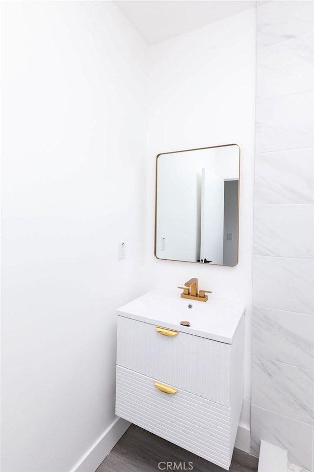 bathroom with hardwood / wood-style floors and vanity