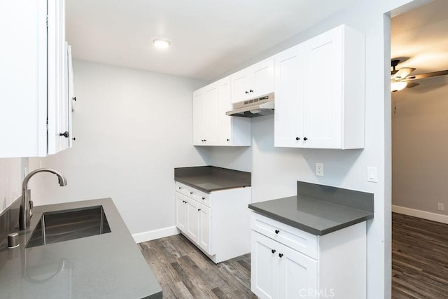 kitchen with ceiling fan, dark hardwood / wood-style flooring, white cabinets, and sink