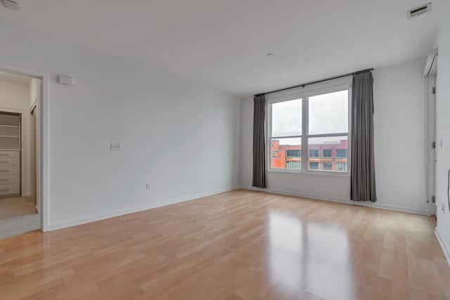 spare room with light hardwood / wood-style flooring