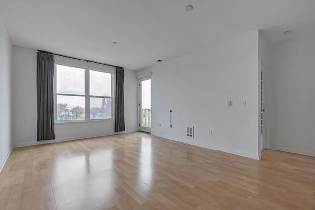 spare room featuring light hardwood / wood-style flooring