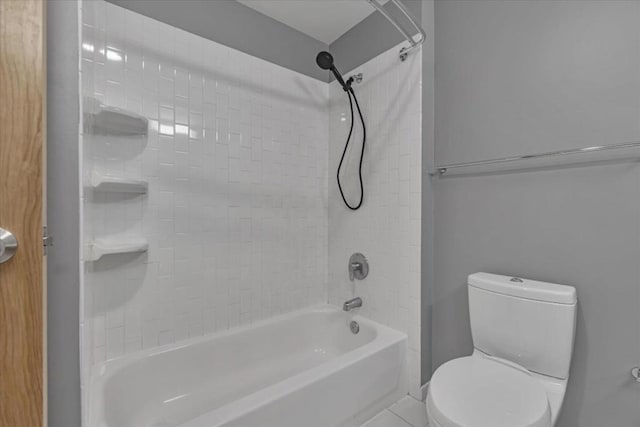 bathroom featuring tiled shower / bath combo and toilet