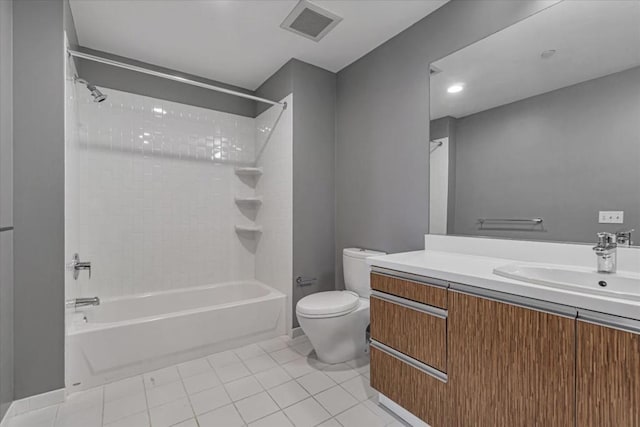 full bathroom with vanity, tile patterned flooring, toilet, and tiled shower / bath