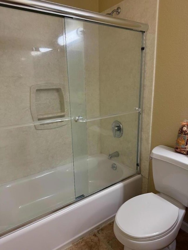 bathroom with toilet and enclosed tub / shower combo