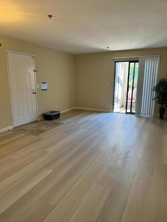 spare room featuring light hardwood / wood-style floors