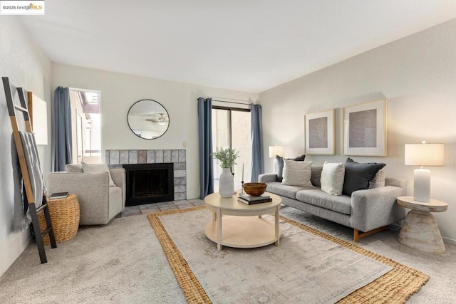 living room featuring light colored carpet, a wealth of natural light, and a fireplace