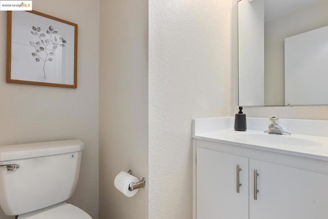 bathroom featuring toilet and vanity