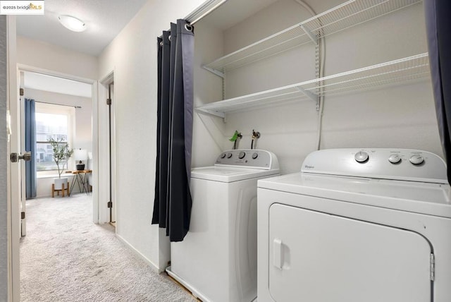 laundry room with carpet floors and washer and clothes dryer