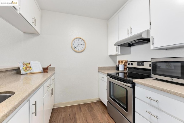 kitchen featuring light wood-type flooring, stainless steel appliances, and white cabinets