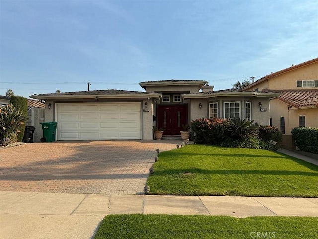 view of front of home with a front lawn and a garage