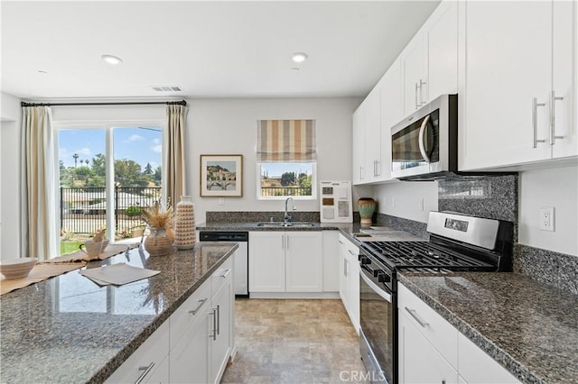 34273 Creek View Ln, Yucaipa, CA 92399 - kitchen with stainless steel appliances, a sink, white cabinets, recessed lighting, and dark stone countertops