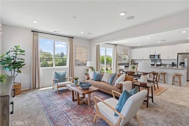 34273 Creek View Ln, Yucaipa, CA 92399 - living room with light carpet, recessed lighting, and baseboards