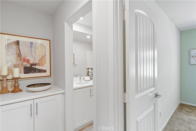 34273 Creek View Ln, Yucaipa, CA 92399 - hallway with a sink, light colored carpet, and baseboards
