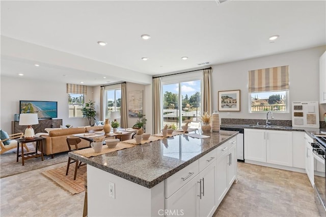 34273 Creek View Ln, Yucaipa, CA 92399 - kitchen featuring dishwasher, a sink, recessed lighting, dark stone countertops, and white cabinetry