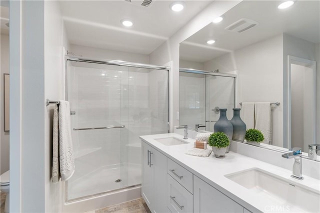 34273 Creek View Ln, Yucaipa, CA 92399 - bathroom featuring recessed lighting, a stall shower, double vanity, and toilet