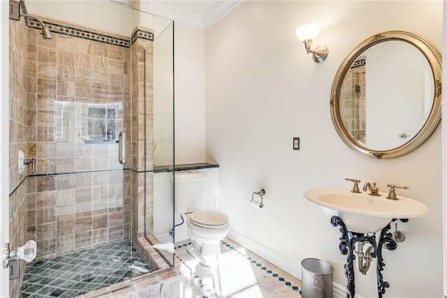 bathroom featuring toilet, ornamental molding, and an enclosed shower