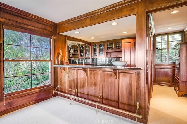 bar with light carpet and wood walls