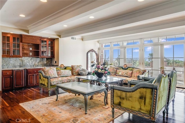 interior space featuring beam ceiling, dark hardwood / wood-style flooring, sink, and ornamental molding