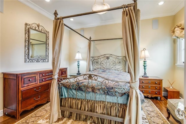 bedroom featuring ornamental molding and wood-type flooring