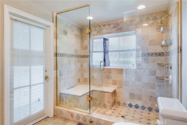 bathroom featuring a shower with shower door