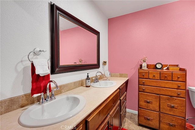 bathroom featuring toilet and vanity