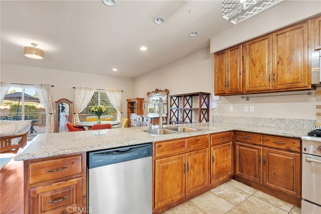 kitchen featuring stainless steel dishwasher, sink, kitchen peninsula, light stone counters, and light tile patterned floors