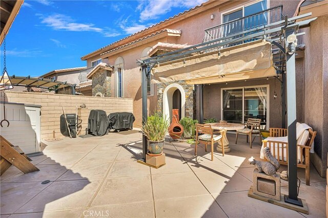 view of patio featuring a balcony