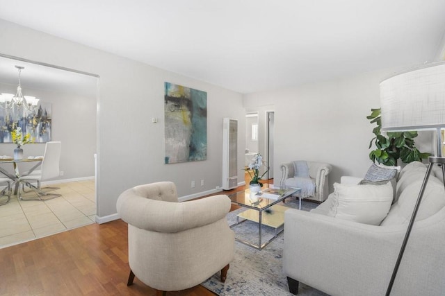 living room with hardwood / wood-style flooring and a notable chandelier