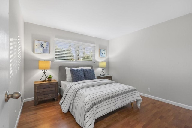 bedroom with dark hardwood / wood-style flooring