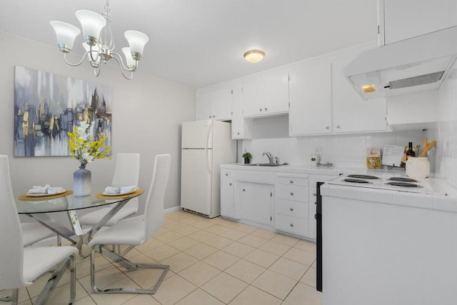 kitchen featuring pendant lighting, white cabinets, white refrigerator, a notable chandelier, and electric range