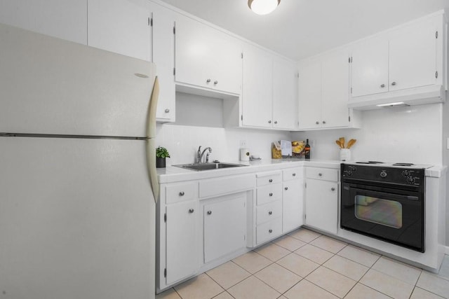 kitchen with light tile patterned flooring, sink, white cabinetry, white refrigerator, and stove