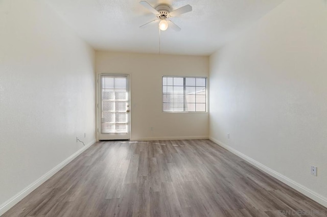 spare room with ceiling fan and hardwood / wood-style flooring