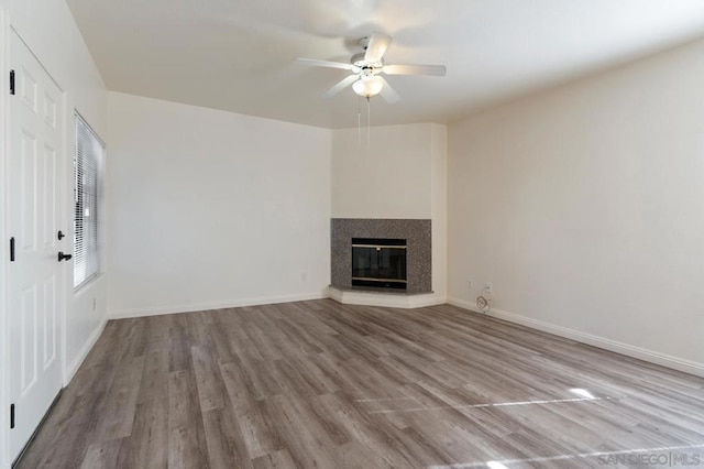 unfurnished living room with ceiling fan and light hardwood / wood-style flooring