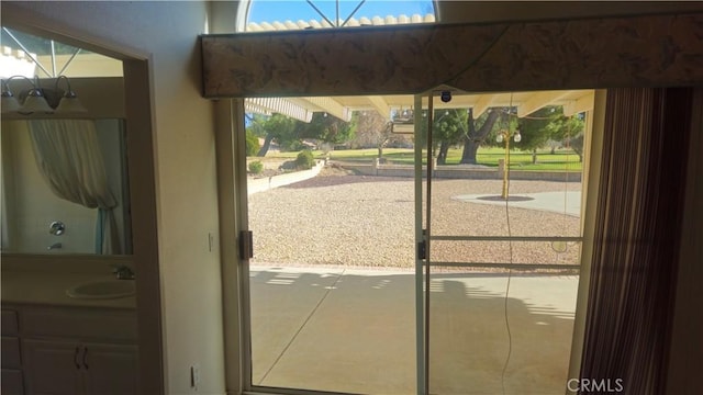 doorway to outside featuring sink