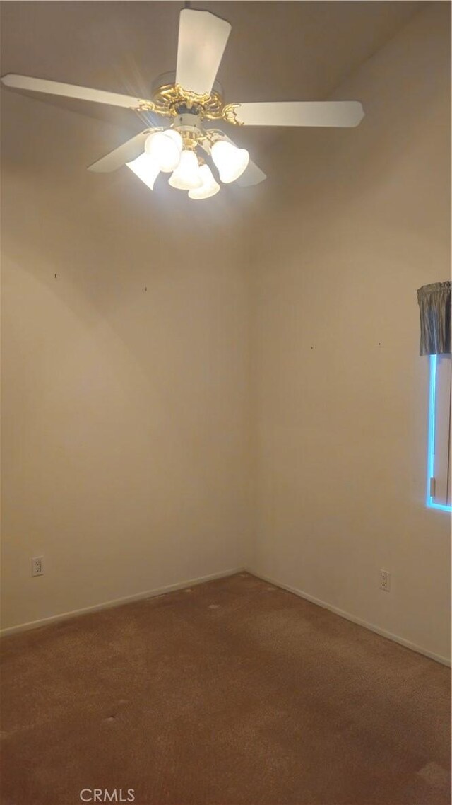 carpeted empty room featuring ceiling fan