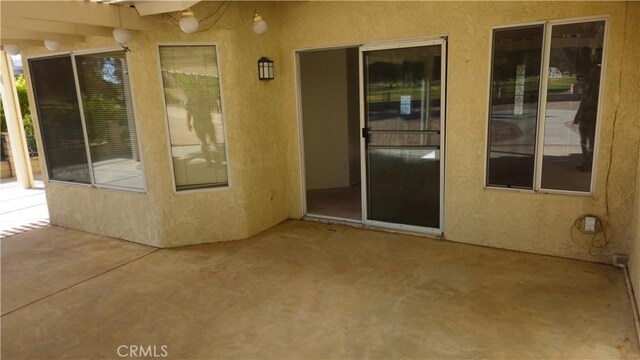 entrance to property featuring a patio