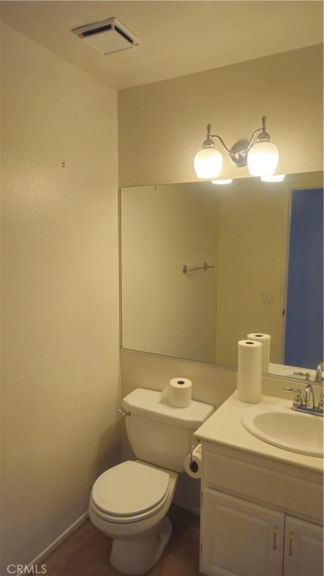 bathroom featuring toilet and vanity