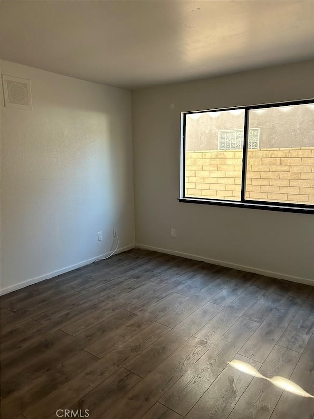 spare room featuring dark hardwood / wood-style floors