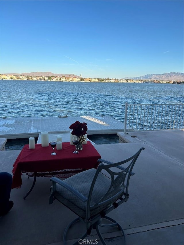 view of dock with a water and mountain view