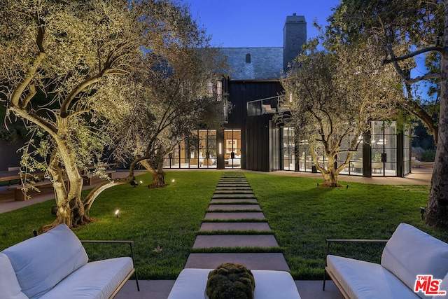 view of yard with a balcony and an outdoor hangout area