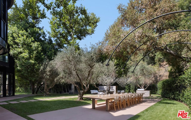 view of home's community with a yard and a patio