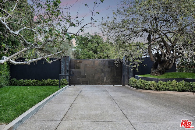 gate at dusk with a lawn