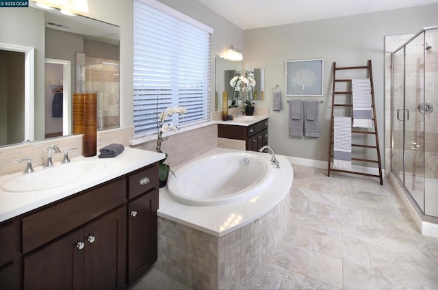 bathroom featuring vanity and shower with separate bathtub