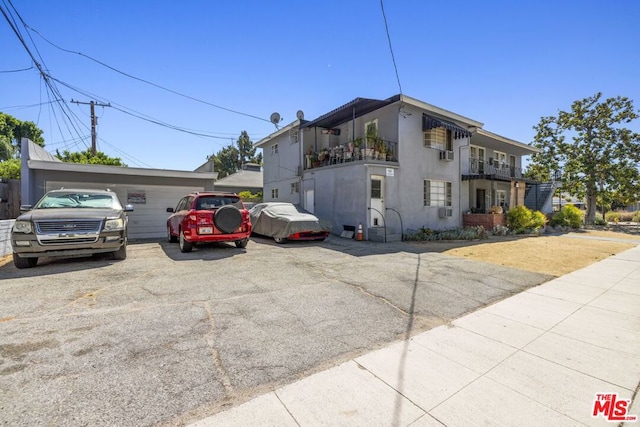 view of front of home featuring a garage and a balcony