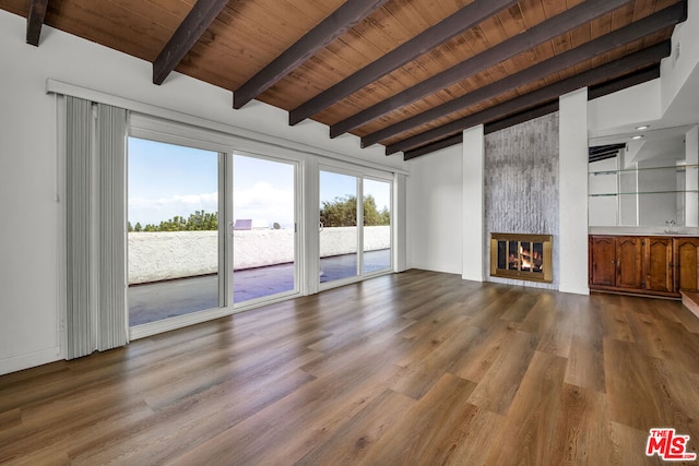 unfurnished living room featuring sink, wood ceiling, a large fireplace, and hardwood / wood-style floors