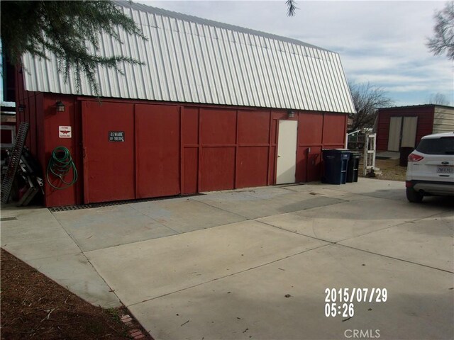 view of home's exterior featuring an outbuilding