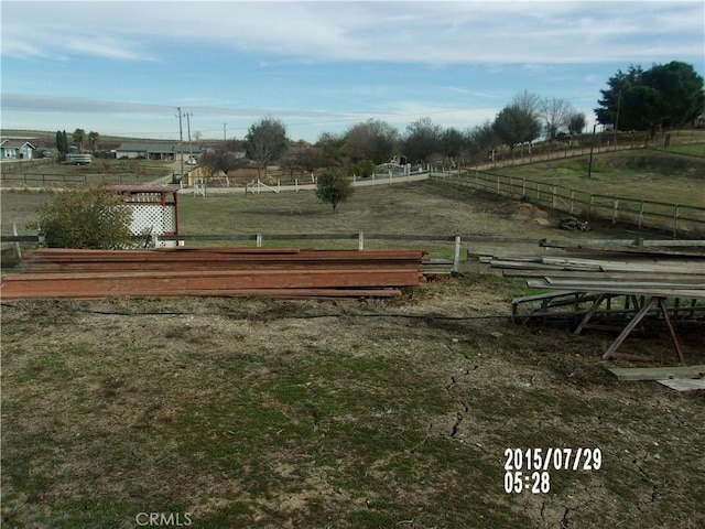 surrounding community with a rural view and fence