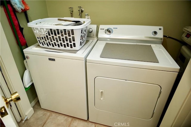 laundry area with laundry area, light tile patterned flooring, and separate washer and dryer