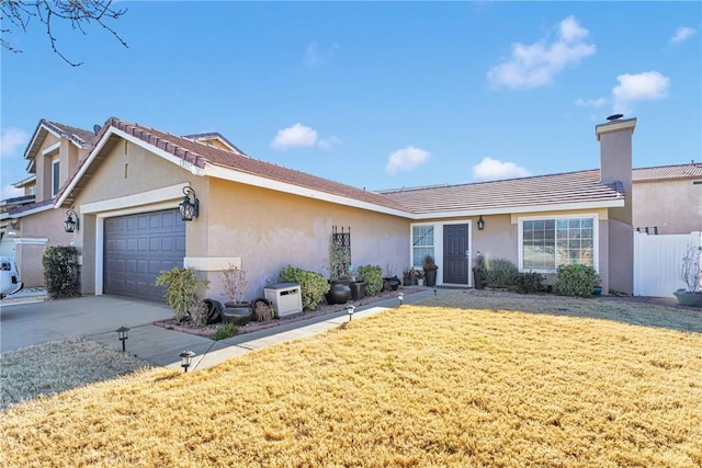 ranch-style home featuring a garage and a front lawn